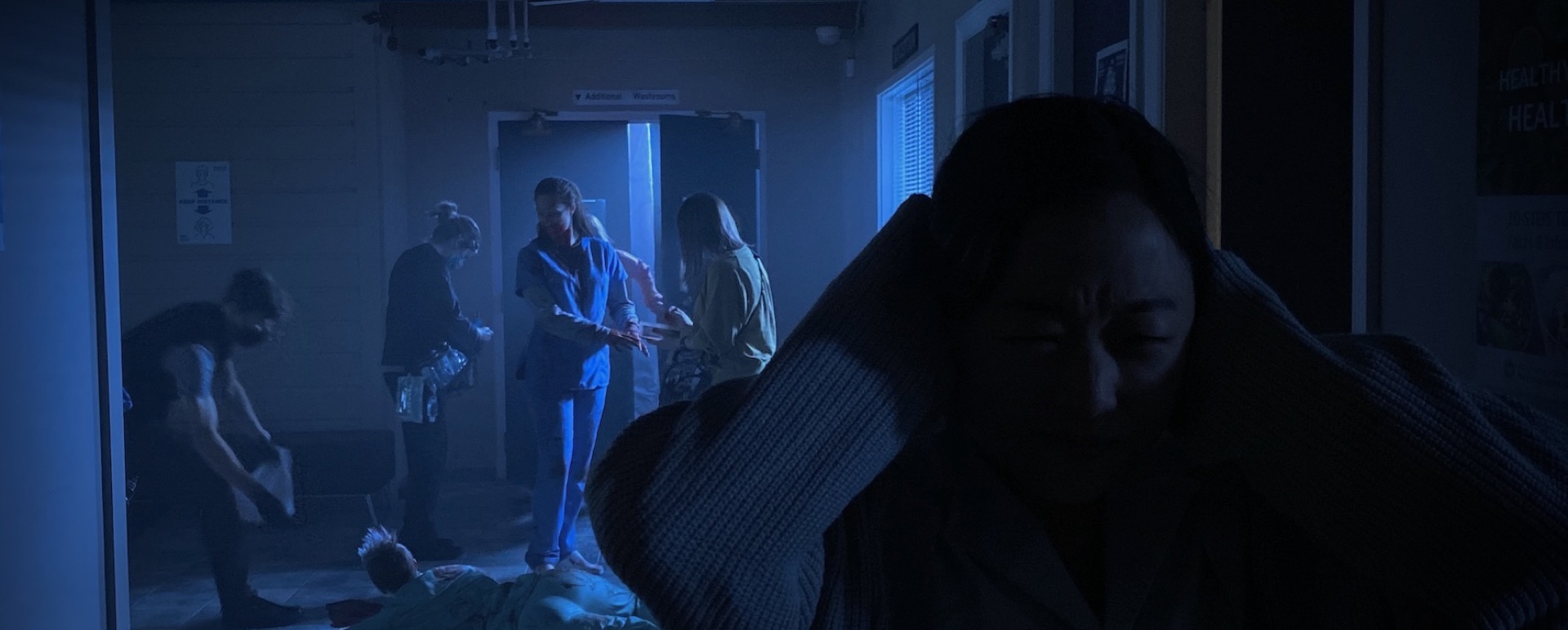 Cinematic still — blue-lit corridor